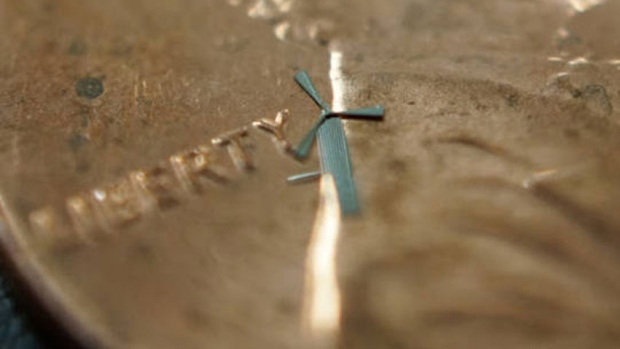 A 'micro-windmill' designed by researchers with the University of Texas at Arlington is shown on top of a penny. The device's designers say the windmills could be used in the future to charge cellphones or power homes.
